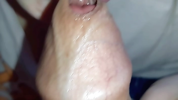 Very close-up of a girl doing blowjob early in the morning - cum in mouth from sweet lips and tongue